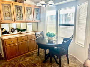 Dining space with hanging lights and baseboards