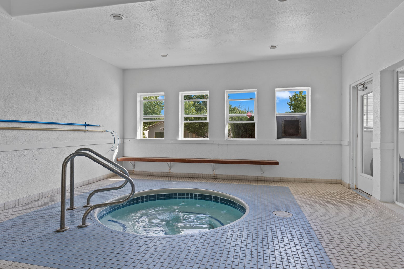 View of pool with a hot tub