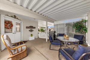 View of patio featuring a gate, outdoor dining space, french doors, and a grill