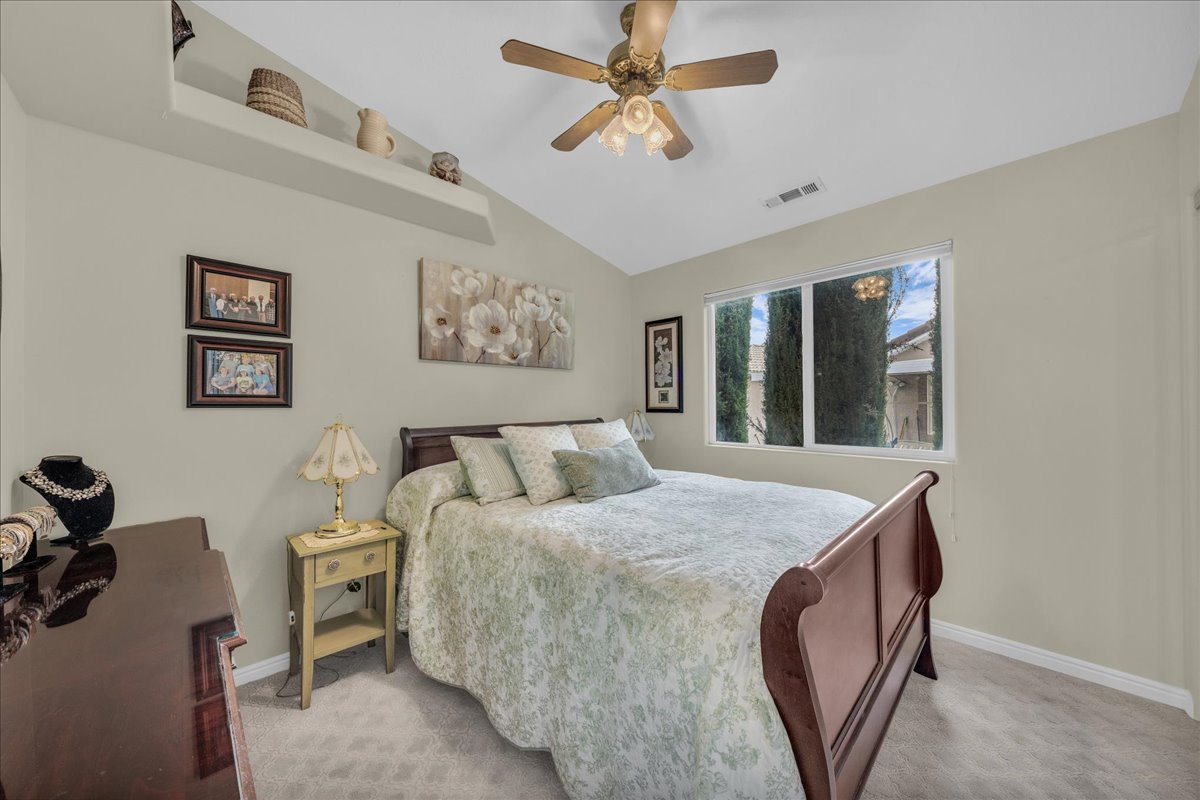 Bedroom featuring carpet floors, a ceiling fan, and lofted ceiling