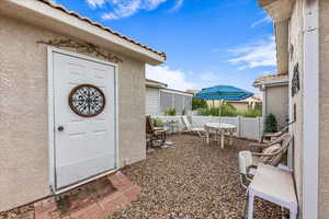 Property entrance with stucco siding and a tiled roof