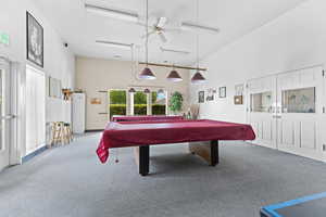 Game room featuring billiards table, a towering ceiling, and ceiling fan