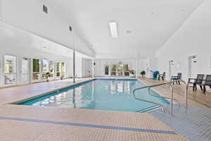 Indoor pool featuring a skylight