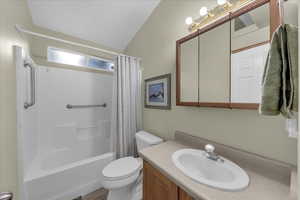 Bathroom with vanity and shower / tub combo with curtain