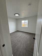 2nd bedroom Unfurnished room featuring carpet flooring, a textured ceiling, and a smoke detector