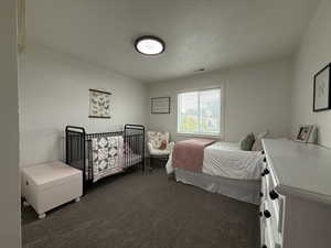 2nd Bedroom featuring carpet flooring and a textured ceiling