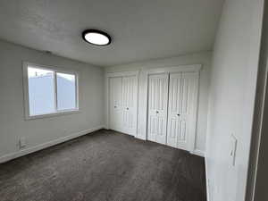 Primary Unfurnished bedroom with multiple closets, a