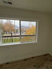 view out family room window with a beautiful tree