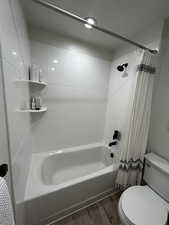 Full bath featuring light wood finished floors and shower / bath combo