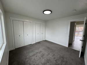 PrimaryUnfurnished bedroom featuring multiple closet