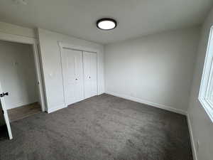 2nd Unfurnished bedroom with carpet and a closet