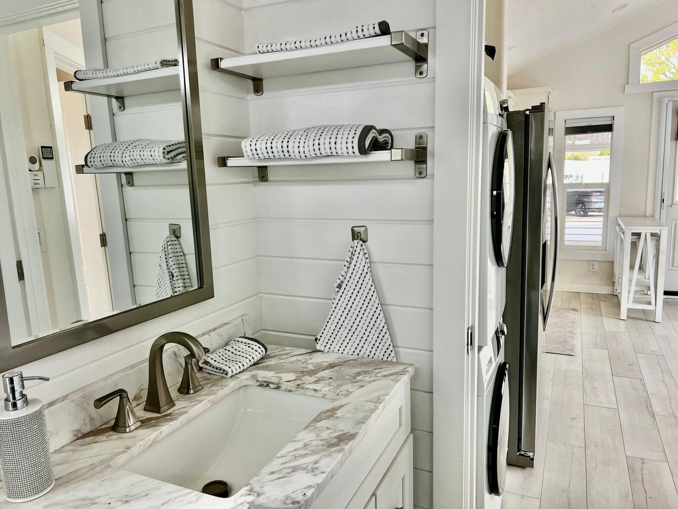 Bathroom with lofted ceiling, vanity, and light wood-style floors