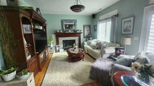 Living area with wood finished floors and a fireplace