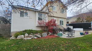 Rear view of property with a patio, a lawn, and stucco siding