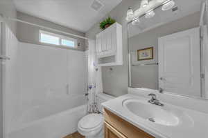 Bathroom featuring shower / bath combo with shower curtain and vanity