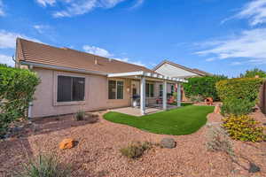 Rear view of house with a patio and stucco siding