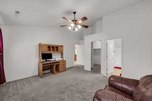 Office with light colored carpet, high vaulted ceiling, and ceiling fan