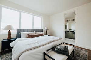 Bedroom with wood finished floors and ensuite bathroom