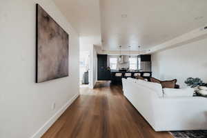 Living area featuring dark wood finished floors and recessed lighting