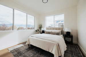 Bedroom featuring a mountain view and wood finished floors