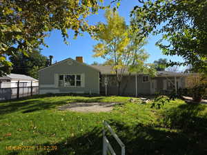 Rear view of property featuring a patio and a chimney