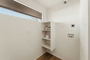 Laundry room featuring washer hookup, dark wood-type flooring, and hookup for an electric dryer