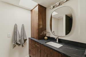 Bathroom featuring vanity and curtained shower
