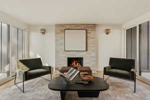 Living area with a tile fireplace and wood finished floors