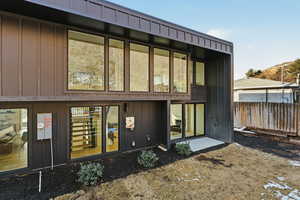 Rear view of house featuring board and batten siding