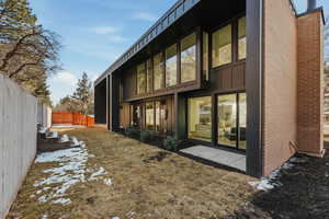 View of side of home featuring a fenced backyard and board and batten siding