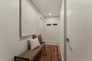 Corridor with recessed lighting and baseboards