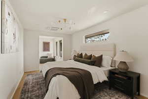 Bedroom featuring cooling unit and wood finished floors