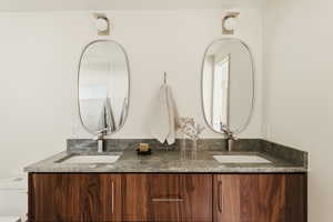 Bathroom with double vanity and toilet