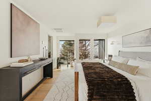Bedroom with light wood-style flooring and cooling unit