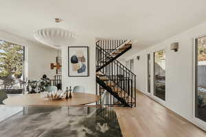 Dining area featuring plenty of natural light, light wood-type flooring, and stairway