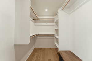 Spacious closet with light wood finished floors