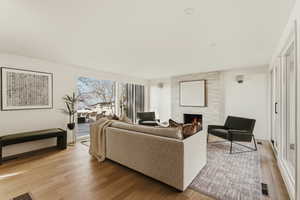 Living room featuring a tile fireplace and light wood finished floors