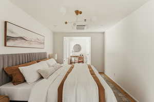 Bedroom featuring cooling unit and wood finished floors