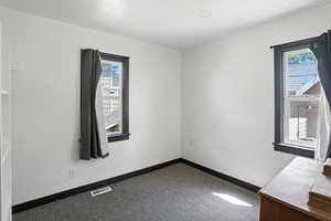 Carpeted spare room with baseboards