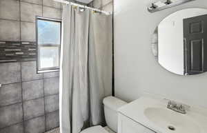 Bathroom with a tile shower and vanity