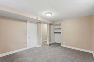 Unfurnished bedroom featuring baseboards and carpet floors