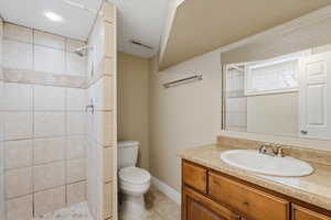 Bathroom featuring vanity, light tile patterned floors, and a stall shower