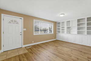 Entryway featuring a textured ceiling and light wood-style floors