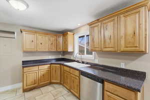 Kitchen featuring dishwasher, light tile patterned floors, light brown cabinets, and recessed lighting
