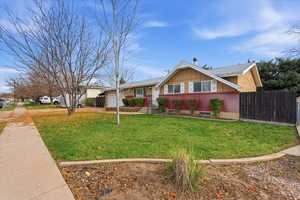 View of front facade with brick siding, board and batten siding, a garage, and driveway