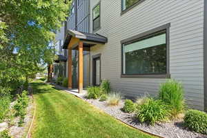 View of side of home with a yard