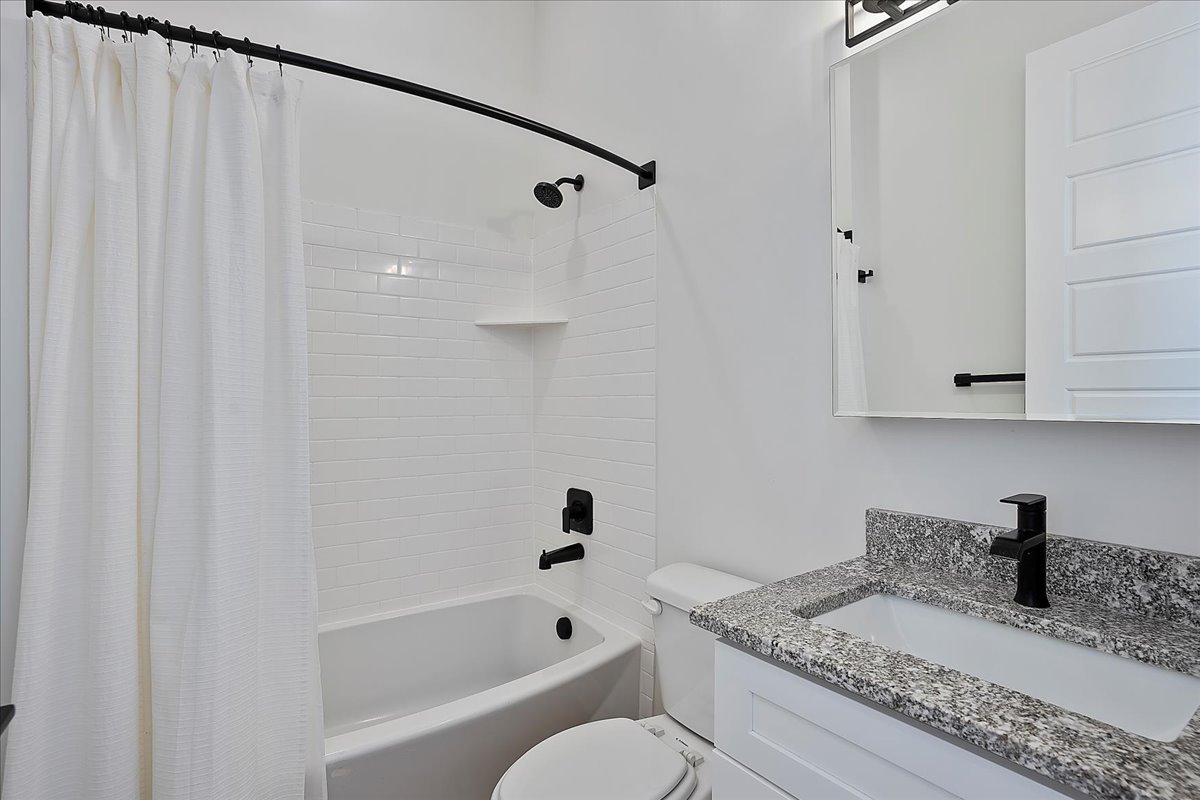 Bathroom with shower / bath combo and vanity