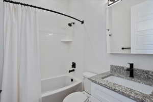 Bathroom with shower / bath combo and vanity