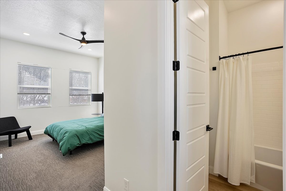 Bedroom featuring ceiling fan, a textured ceiling, recessed lighting, and dark carpet