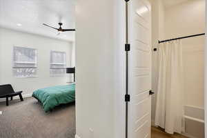 Bedroom featuring ceiling fan, a textured ceiling, recessed lighting, and dark carpet